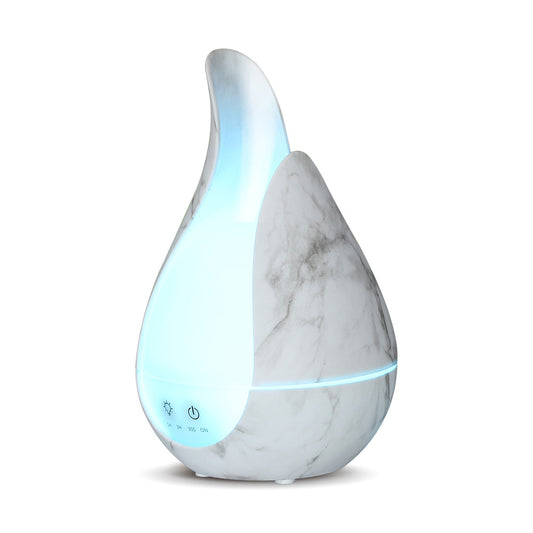 Aroma Humidifier in modern living room with visible mist, soft daylight