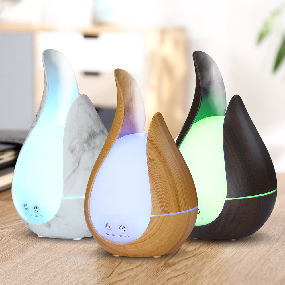 Aroma Humidifier with LED light on desk emitting fine mist